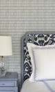 Belfour Indigo headboard from the Michael Szell collection paired with Crochet Wallpaper in Cobalt, designed by WEIN Interiors in Willistown, Pennsylvania – a composed bedroom of bold pattern and rich texture.